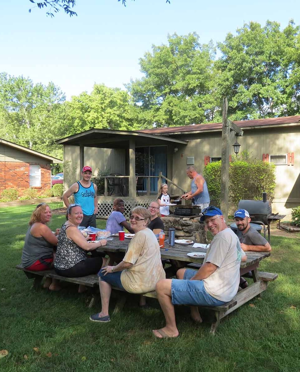 Family group gathered outside cabin 6 at the White Hole Resort