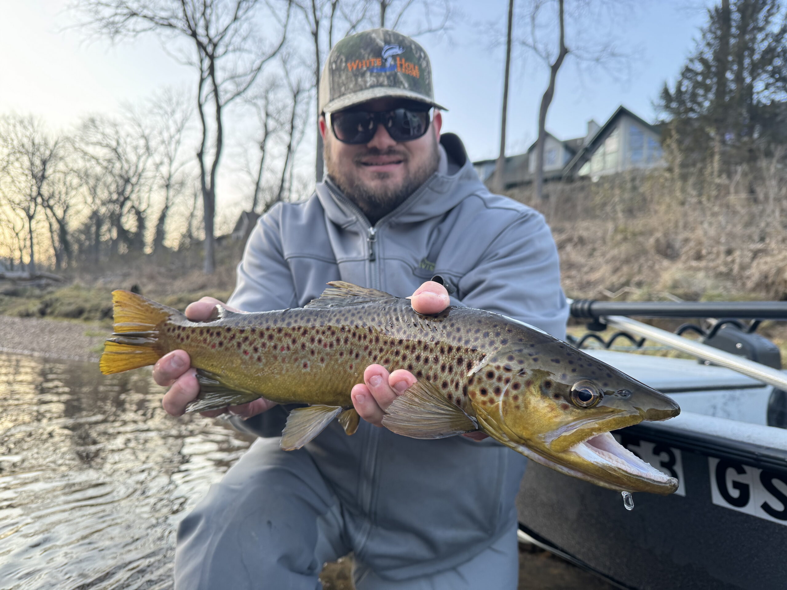 White Hole Resort guide holding a brown trout caught on the fly