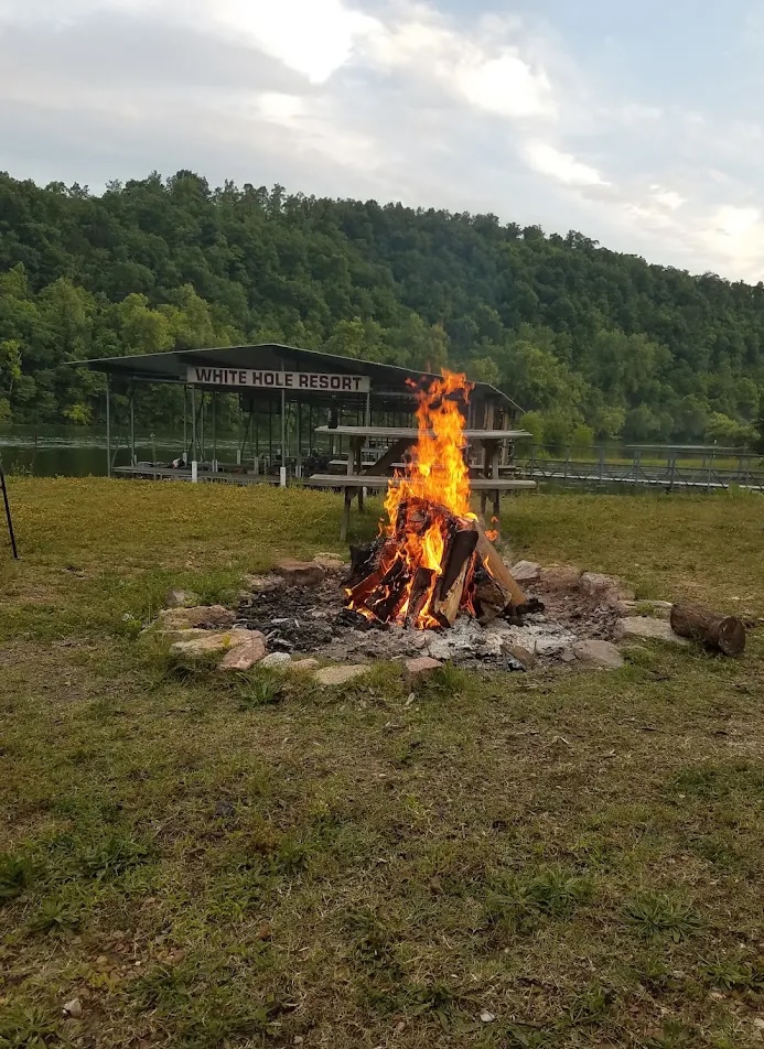 Family group gathered outside cabin 6 at the White Hole Resort
