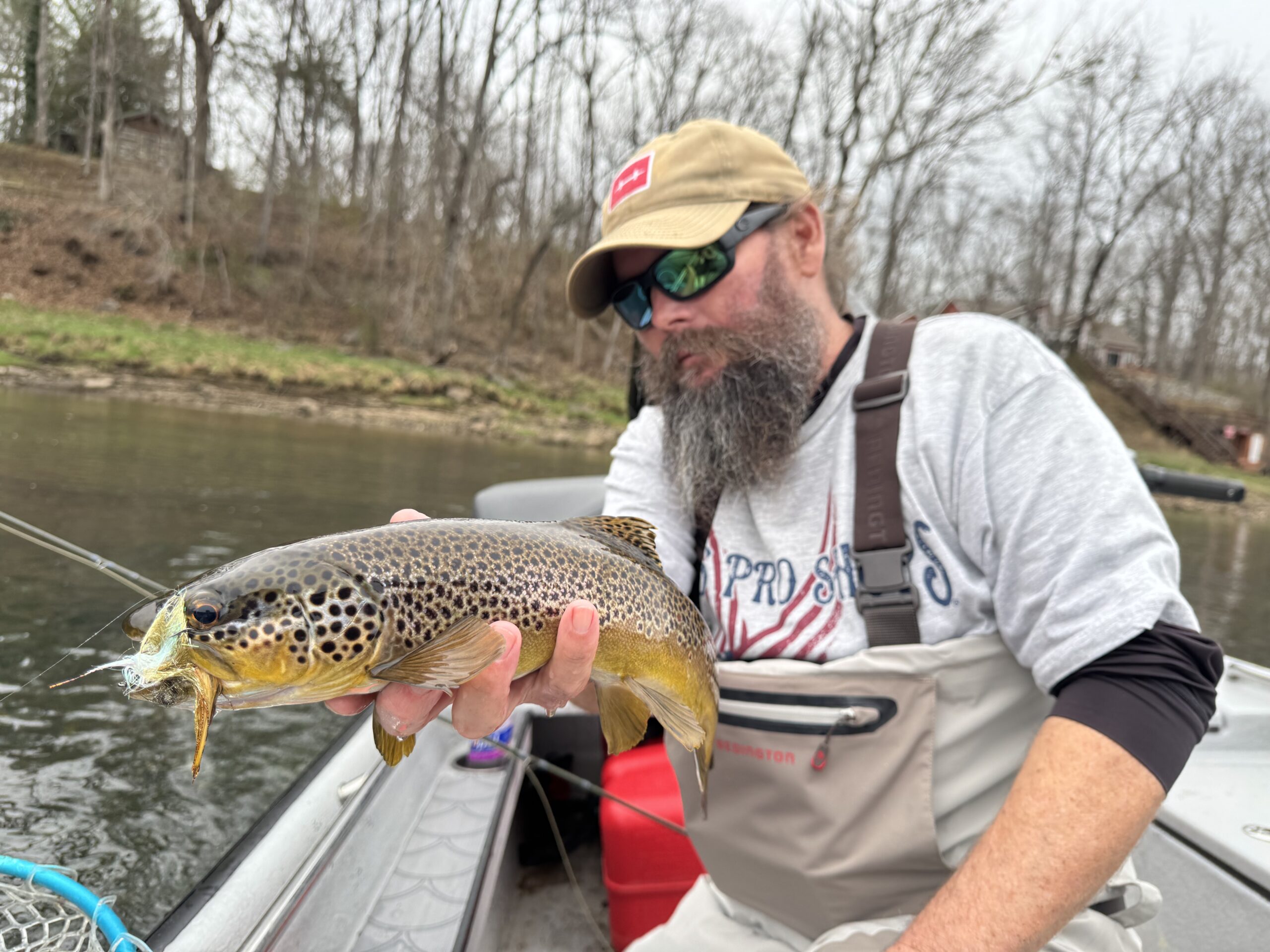 Guide Jeff Arnold holding his freshly caught brown trout caught on the White River on fly